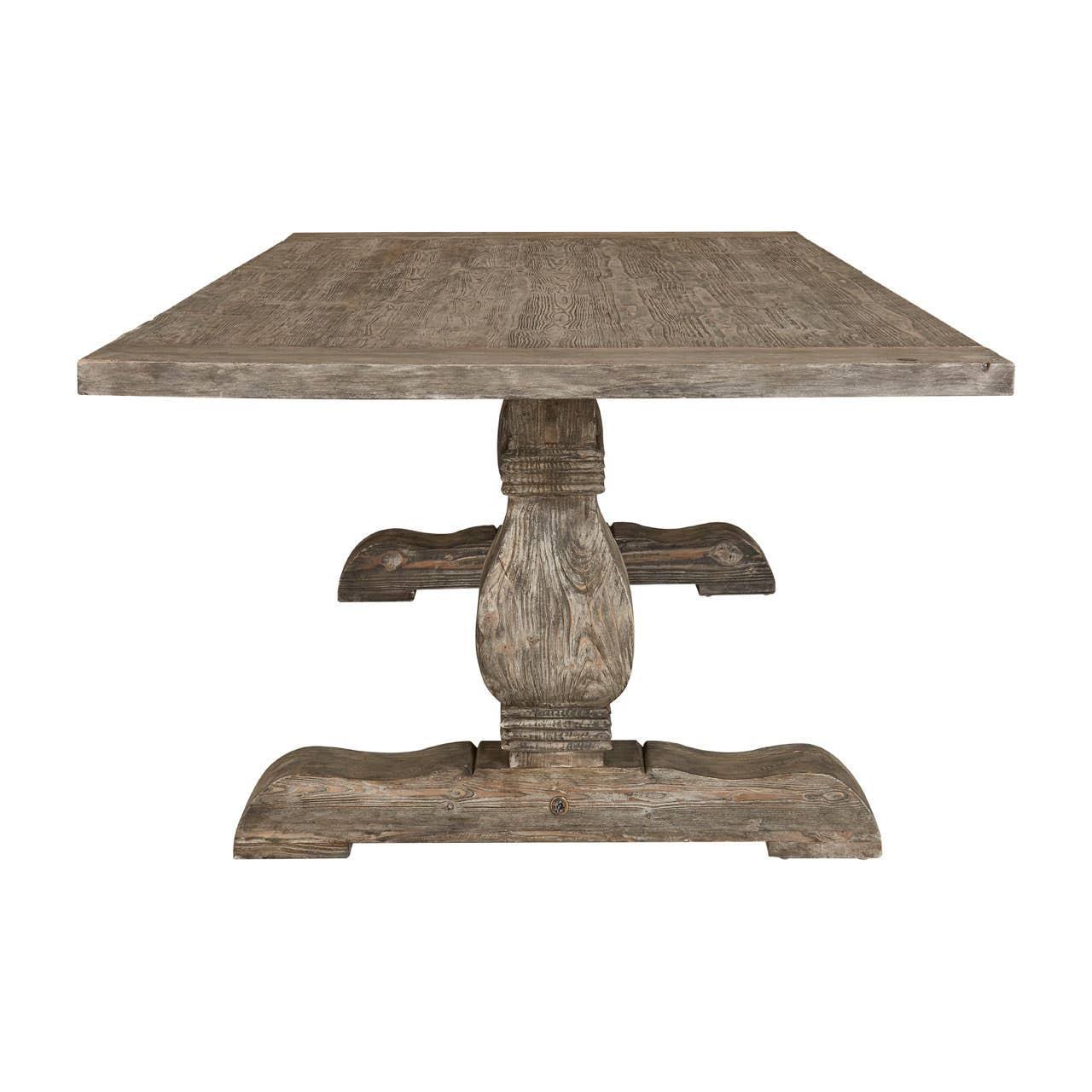 Rustic wooden dining table with square top and carved pedestal base, front view
