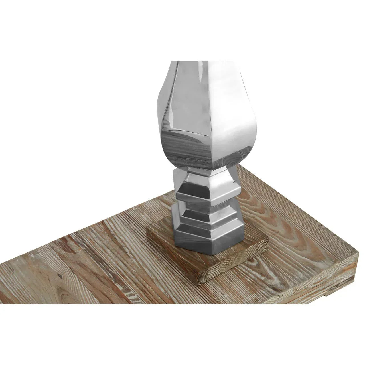 Close view of wooden table with polished metal leg detail