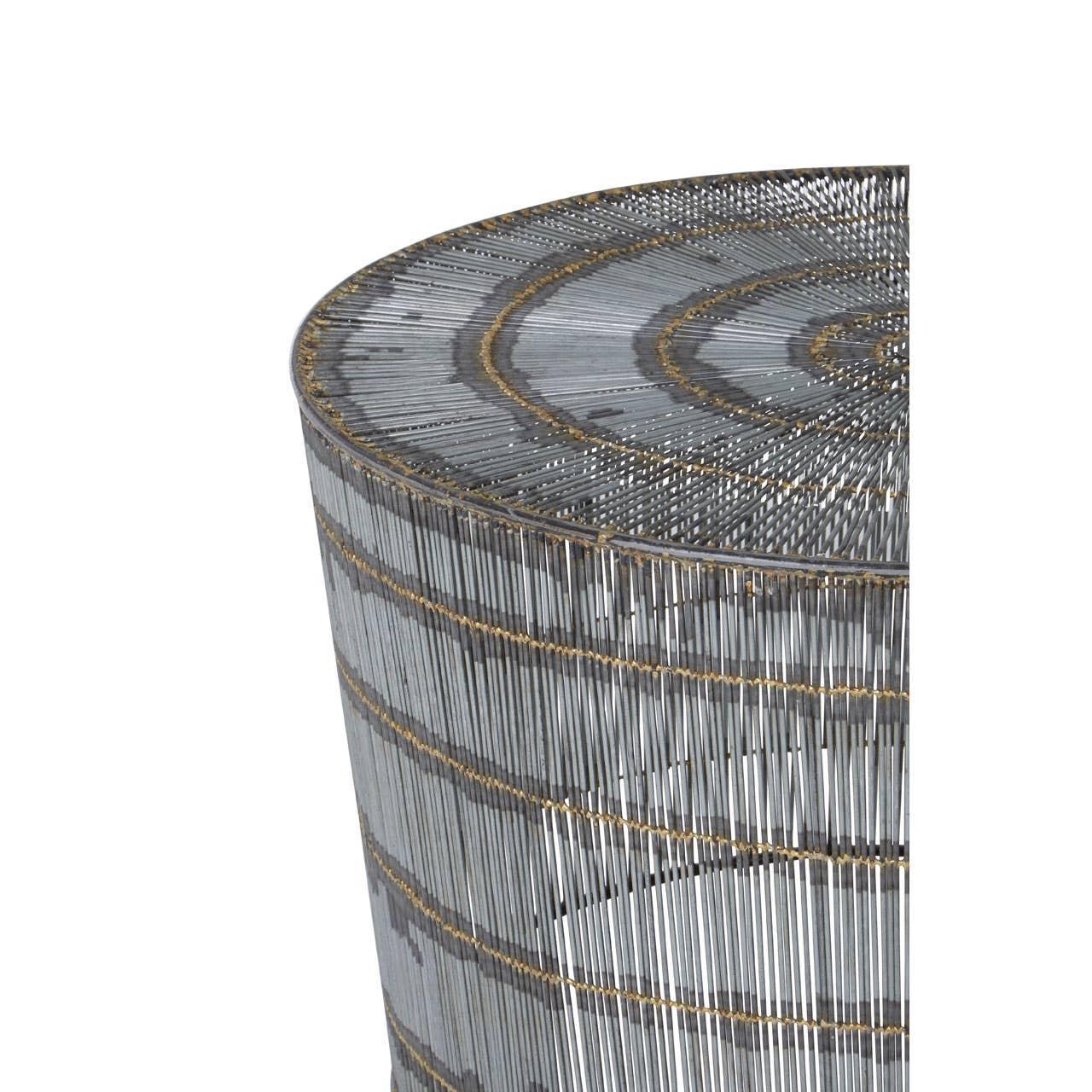 Round metal side table with vertical wire detailing and gold accent bands, close-up view