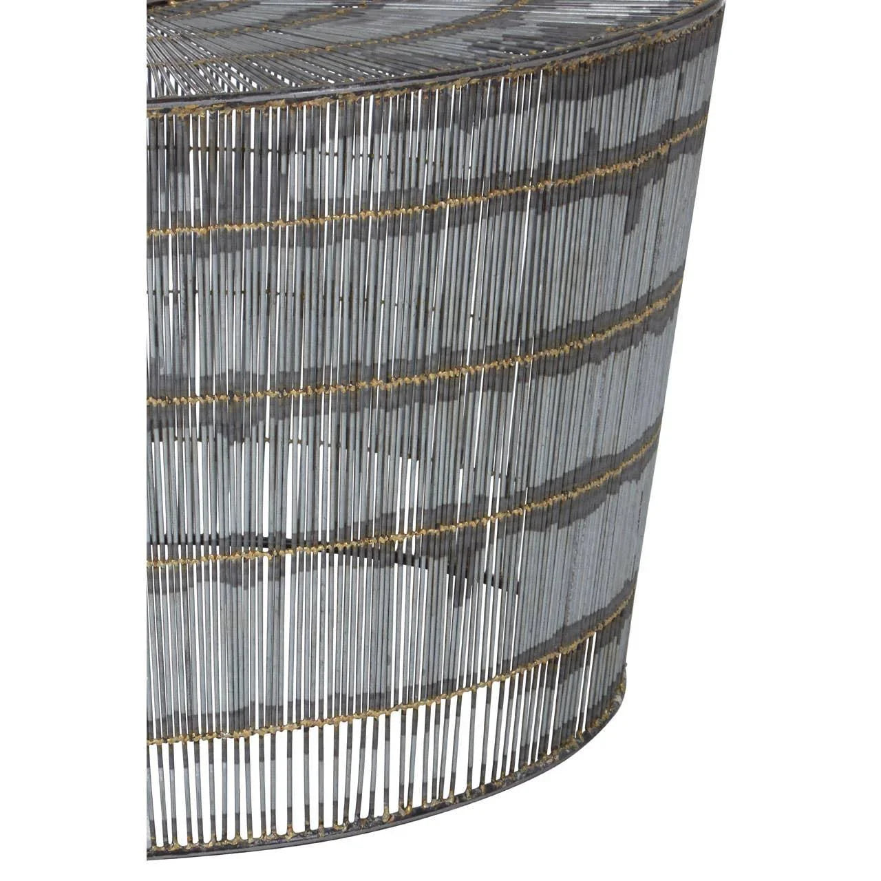 Closeup of round metal wire side table with gold accents and openwork design