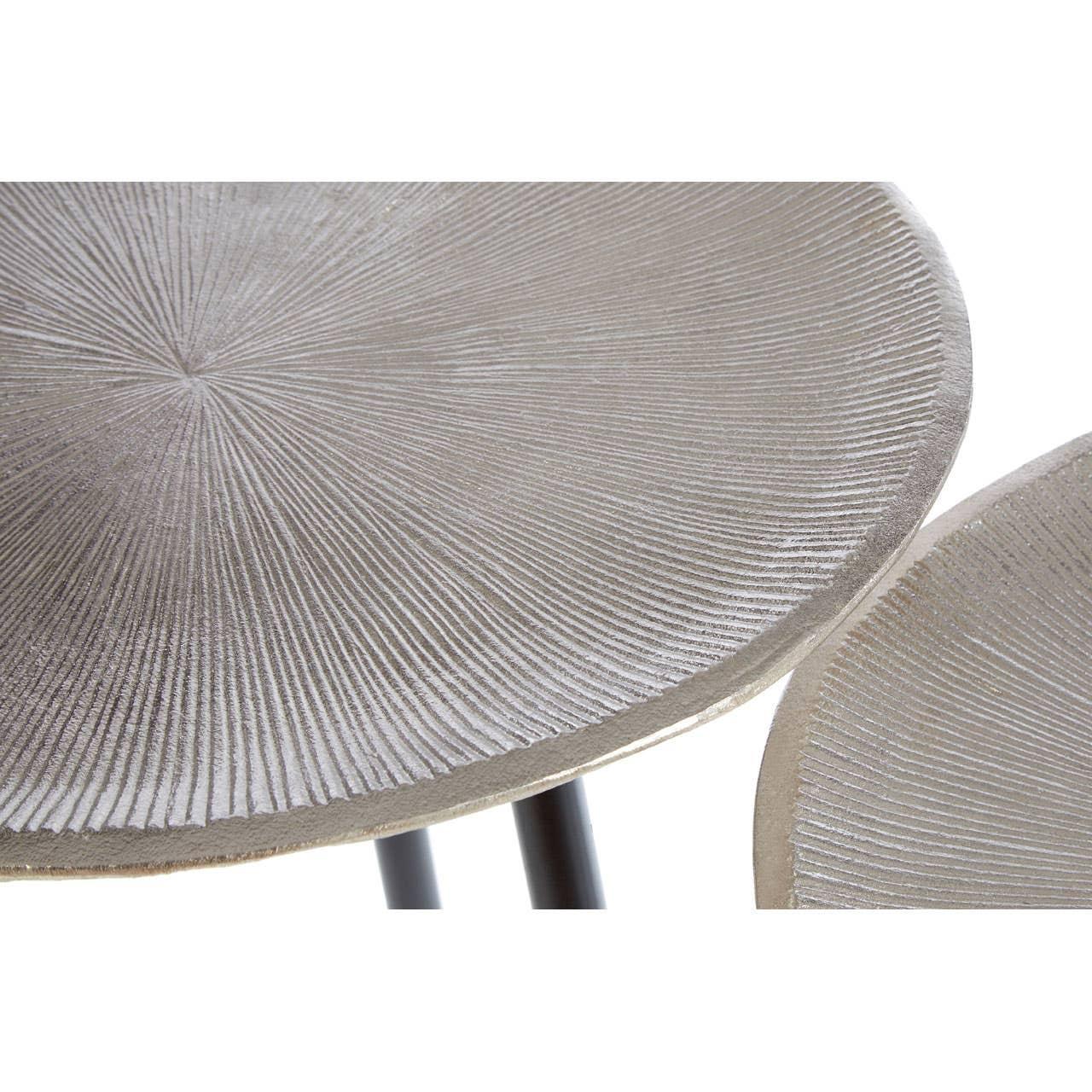 Textured round metal side table top with radiating line pattern, partial view of legs