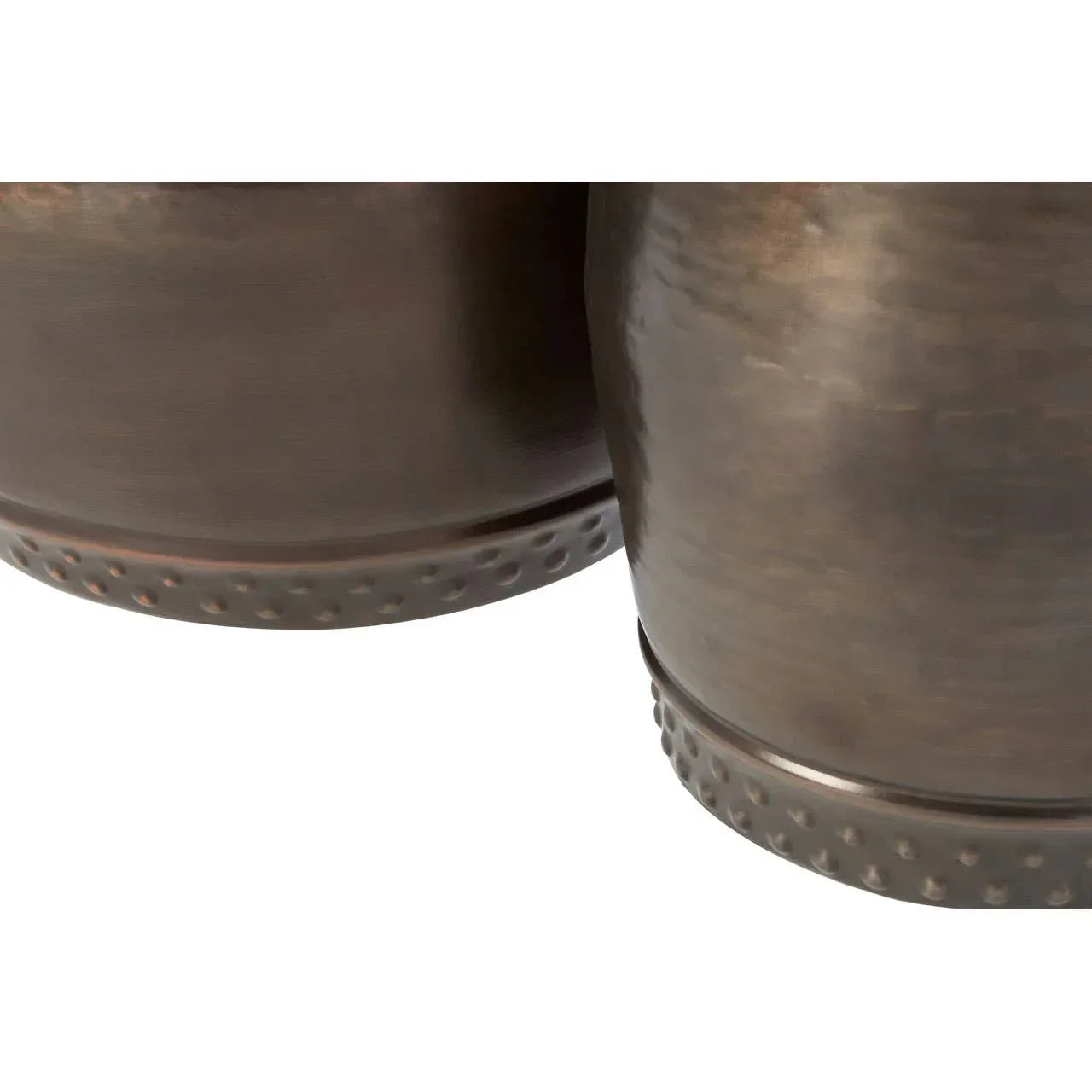 Closeup of bronze metal planter pots with textured dotted base detail
