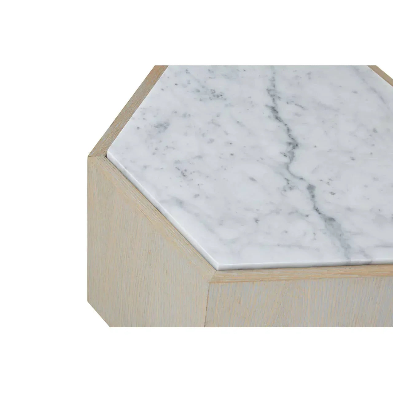 Hexagonal marble top table with light wood base, close-up corner view