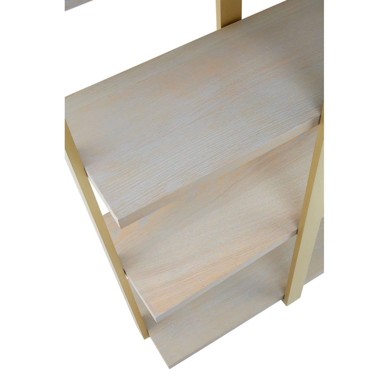 Closeup of light wood shelving unit with gold metal frame, showing shelf detail and finish
