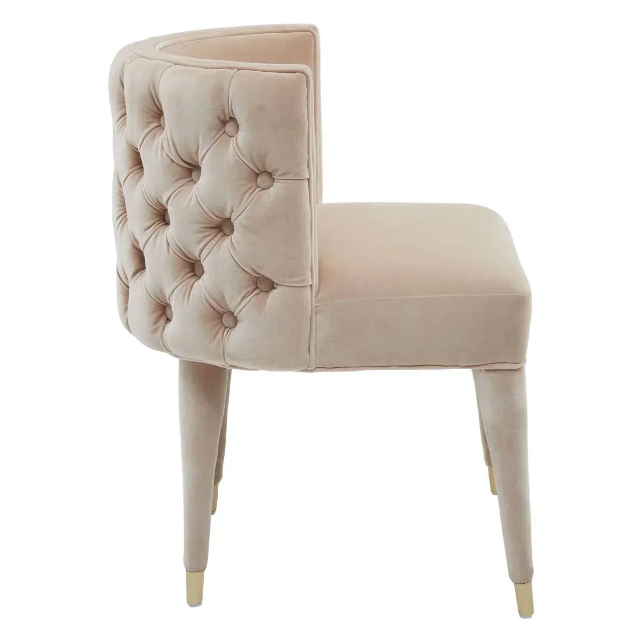beige velvet accent chair with tufted backrest and gold-tipped legs, side view