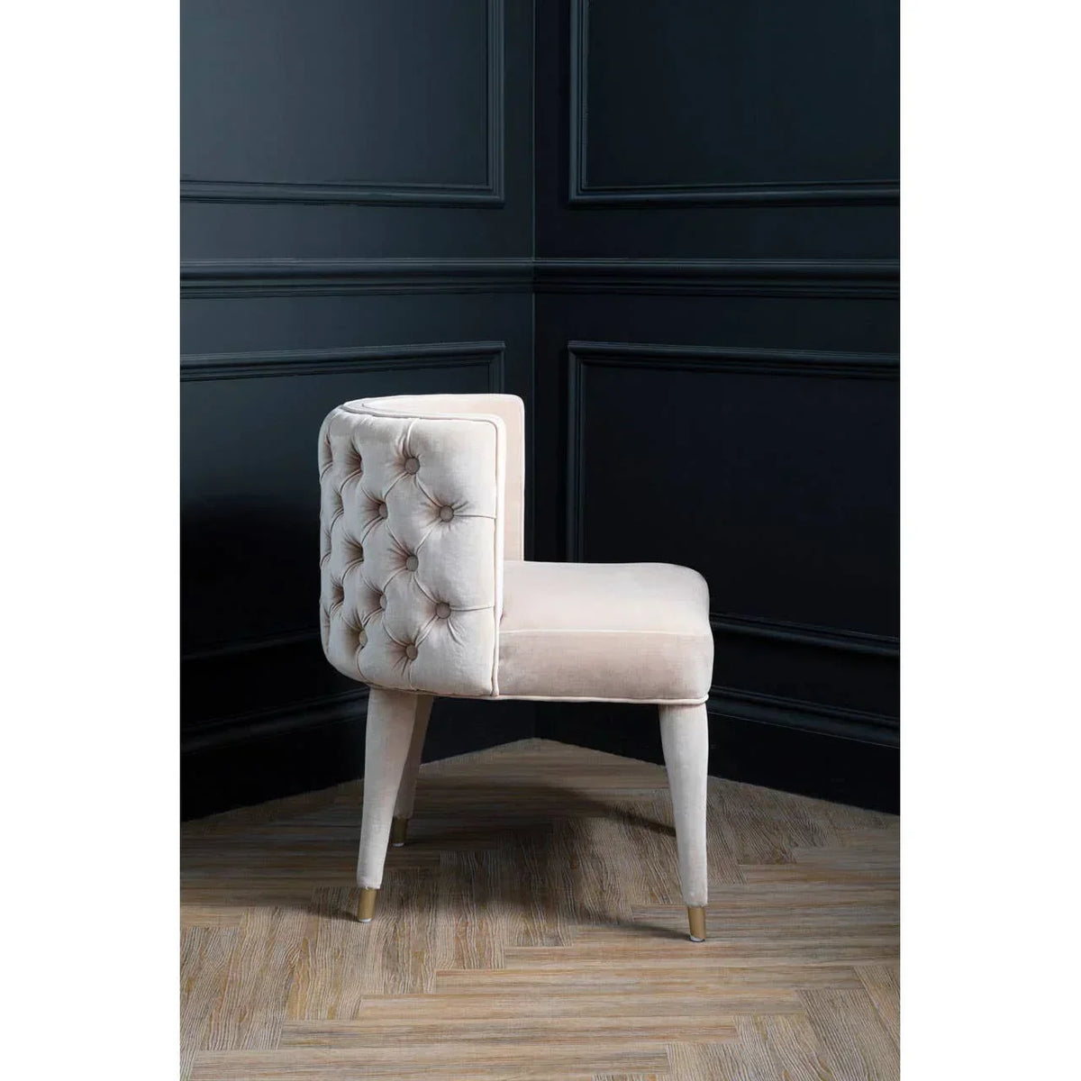 Velvet accent chair with tufted backrest and wooden legs in modern interior corner