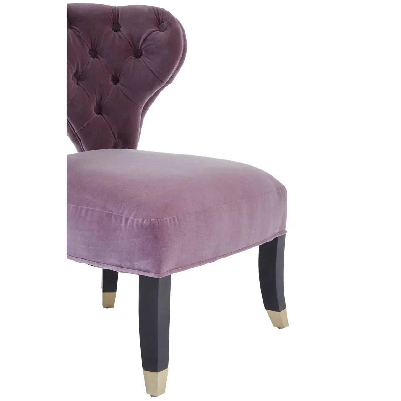 Purple velvet accent chair with button-tufted backrest and black legs with gold tips