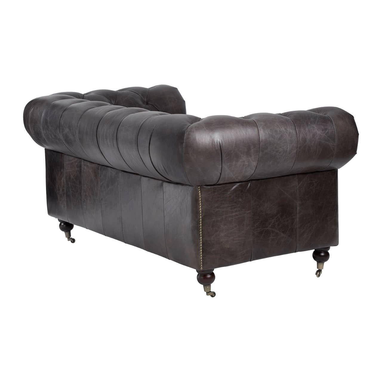 Chesterfield 2 seat sofa upholstered in dark grey-brown leather, featuring a tufted backrest and rolled arms. The sofa rests on four metal caster wheels, providing mobility. The overall design showcases a classic, elegant style suitable for various interior decor