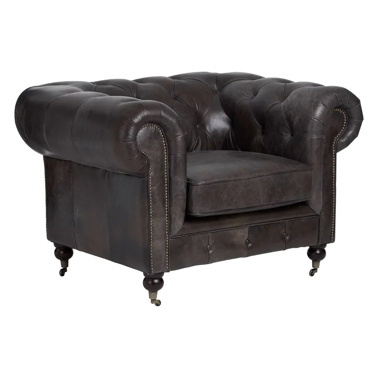 Dark brown leather armchair with button-tufted back and studded arms on wooden castor legs