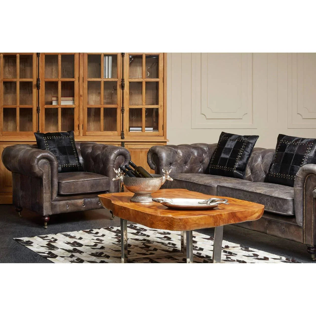 Grey leather Chesterfield sofa set with black cushions, wooden coffee table, glass cabinet
