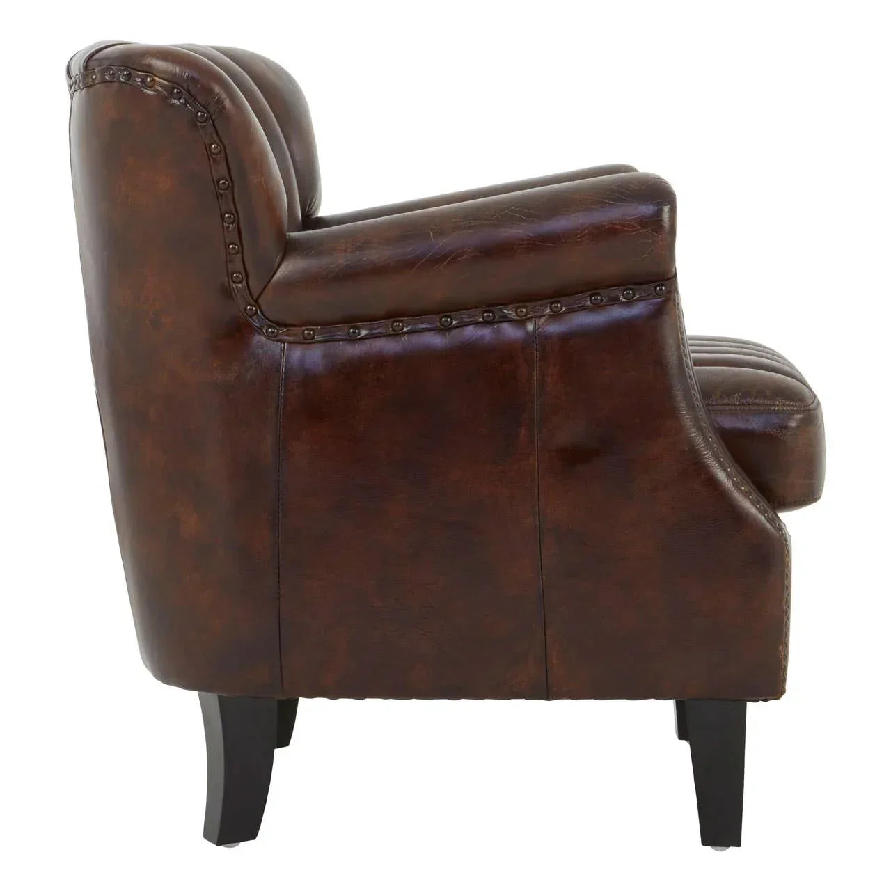 Side view of brown leather armchair with studded trim and dark wooden legs