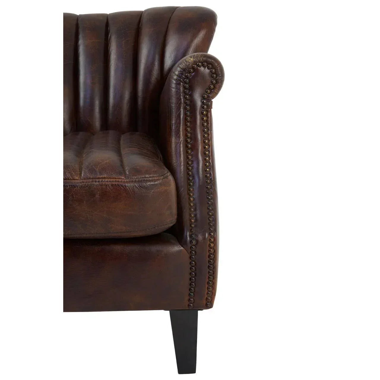 Close-up of brown leather sofa armrest with button details and vertical stitching