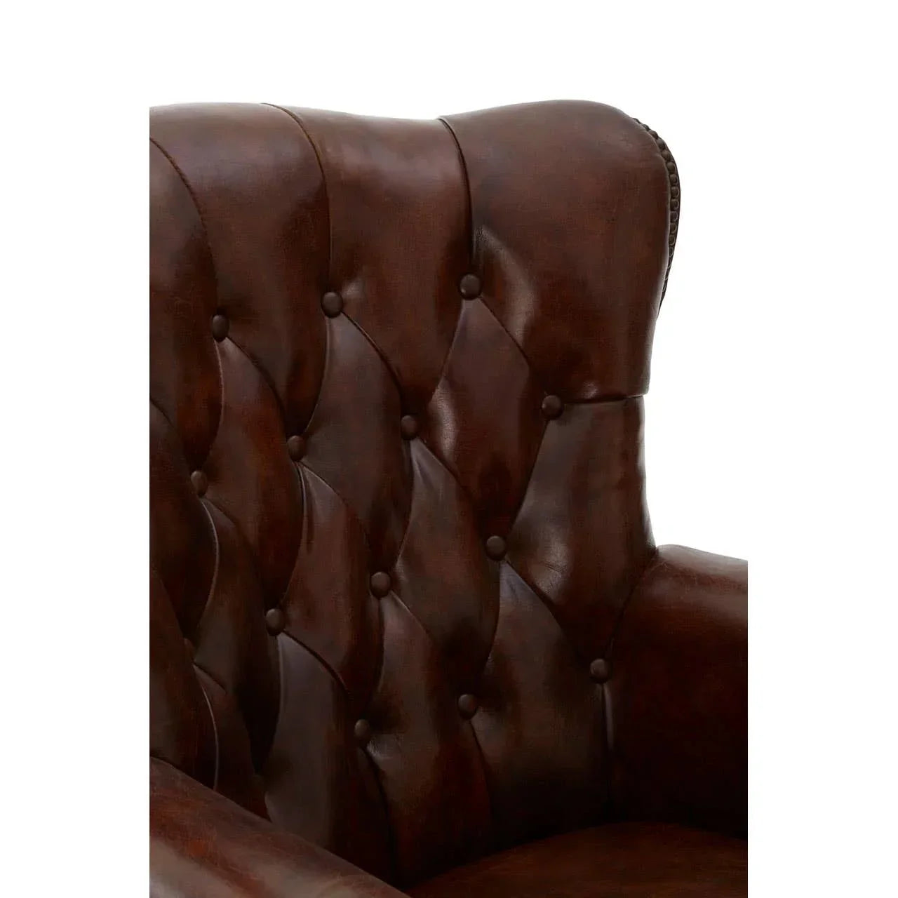 Close-up of brown leather armchair with button-tufted backrest and winged side detail