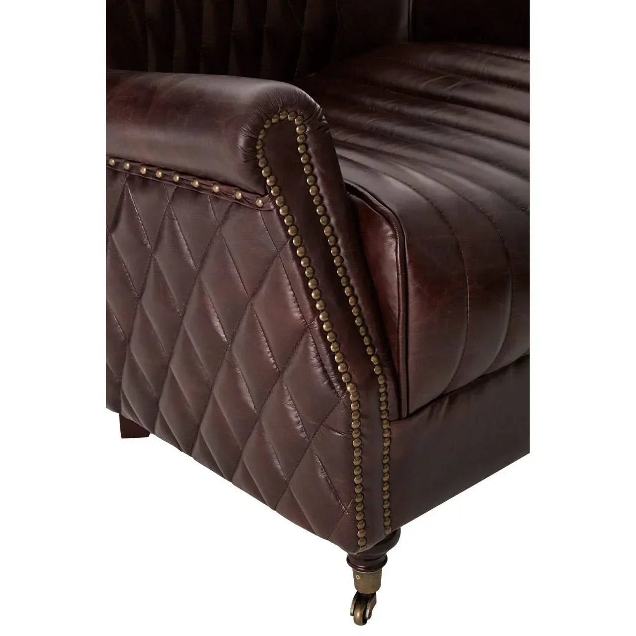 Brown leather sofa arm with diamond stitching, brass stud trim, and front castor wheel
