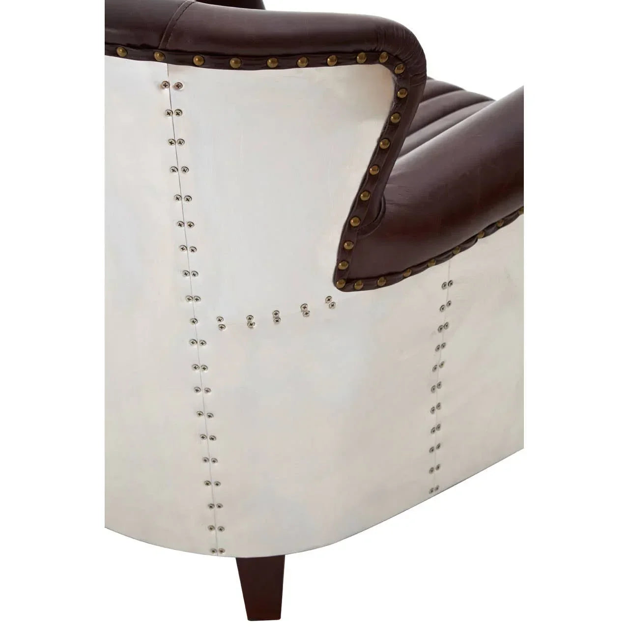 Closeup of brown leather armchair with studded metal back and wooden leg