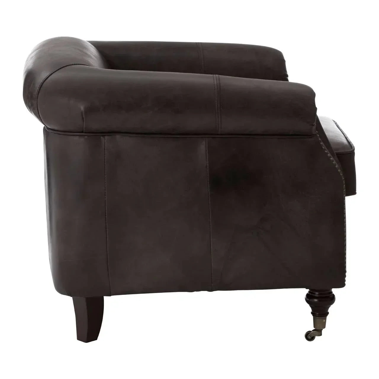 Side view of dark brown leather armchair with wooden legs and front caster