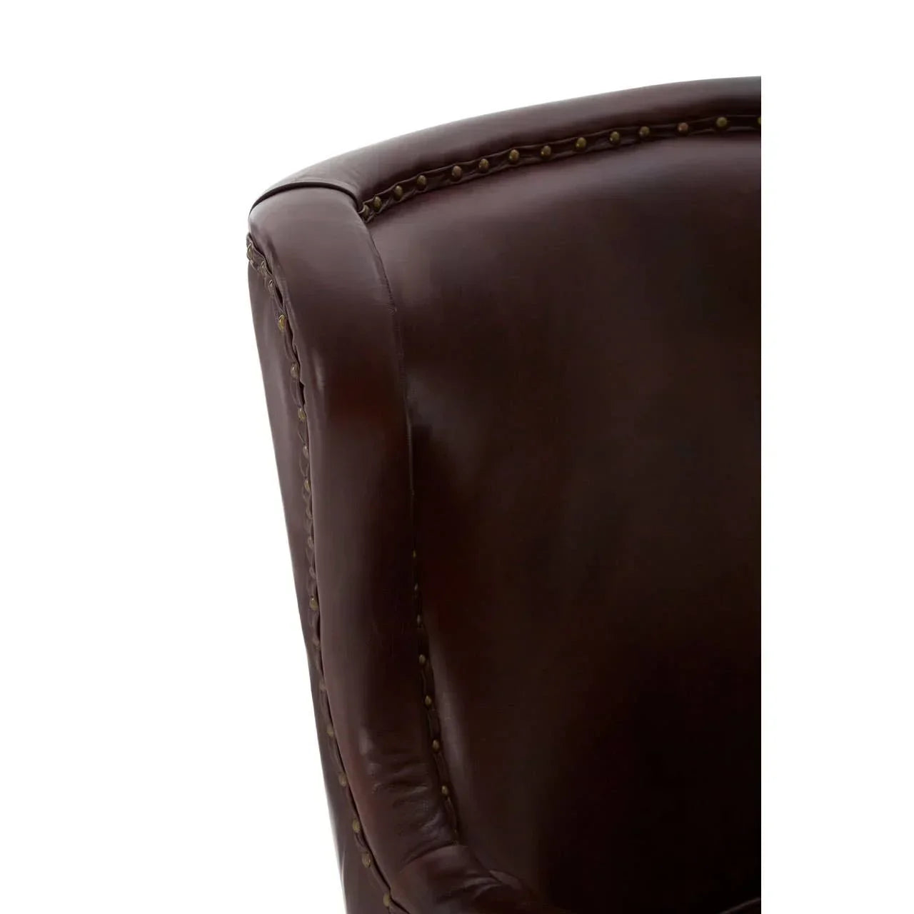 Close up of dark brown leather armchair with brass stud detail on armrest