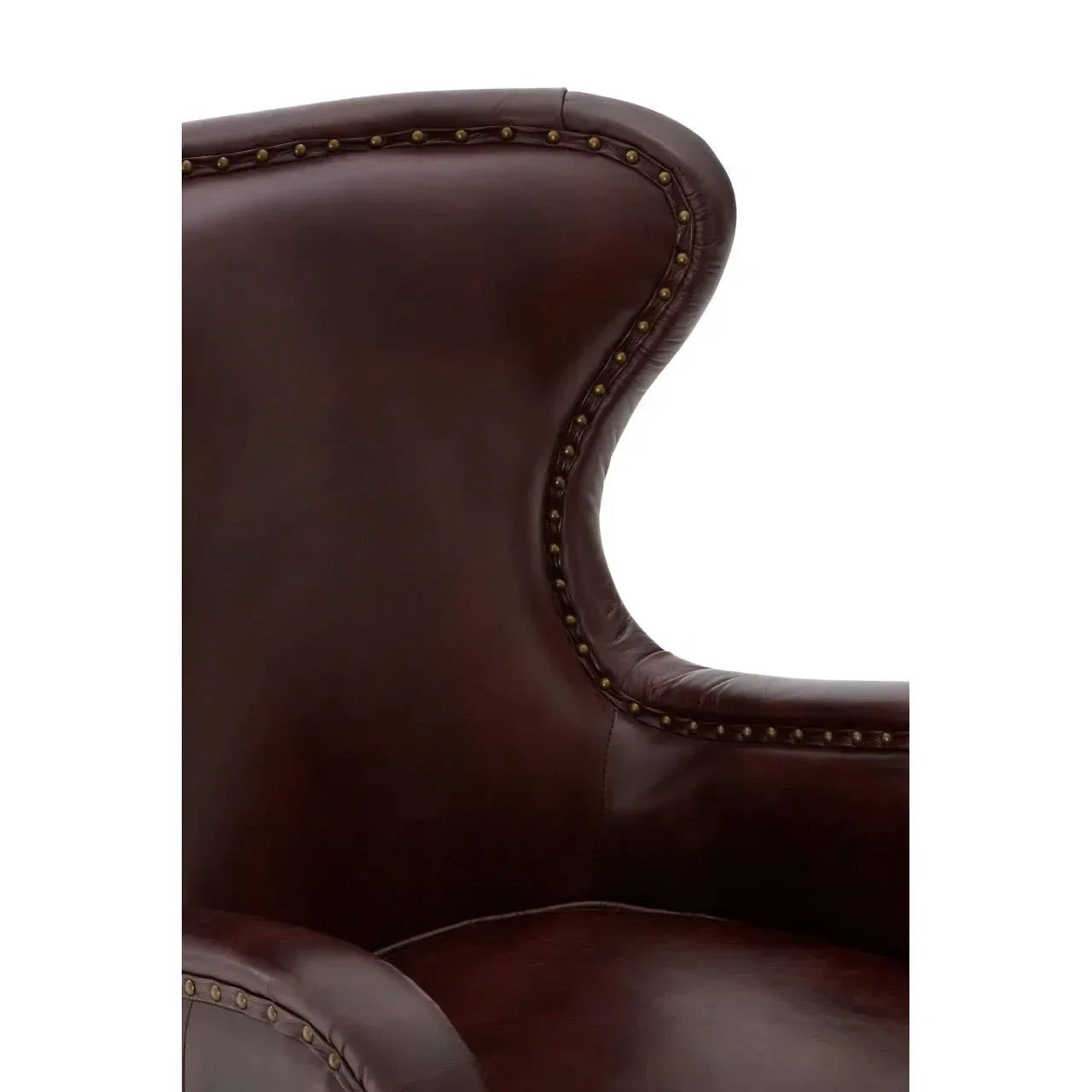 Close up of brown leather armchair with winged back and brass stud detailing