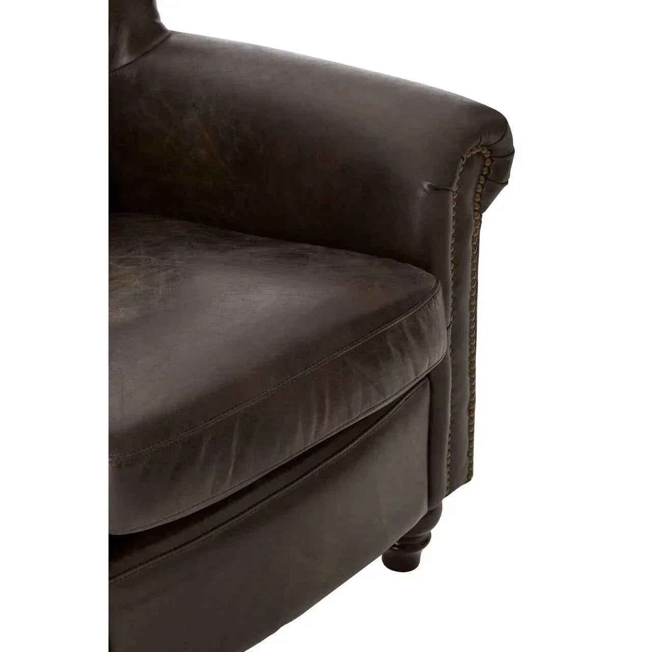 Close-up of brown leather sofa arm with stud detailing and wooden leg