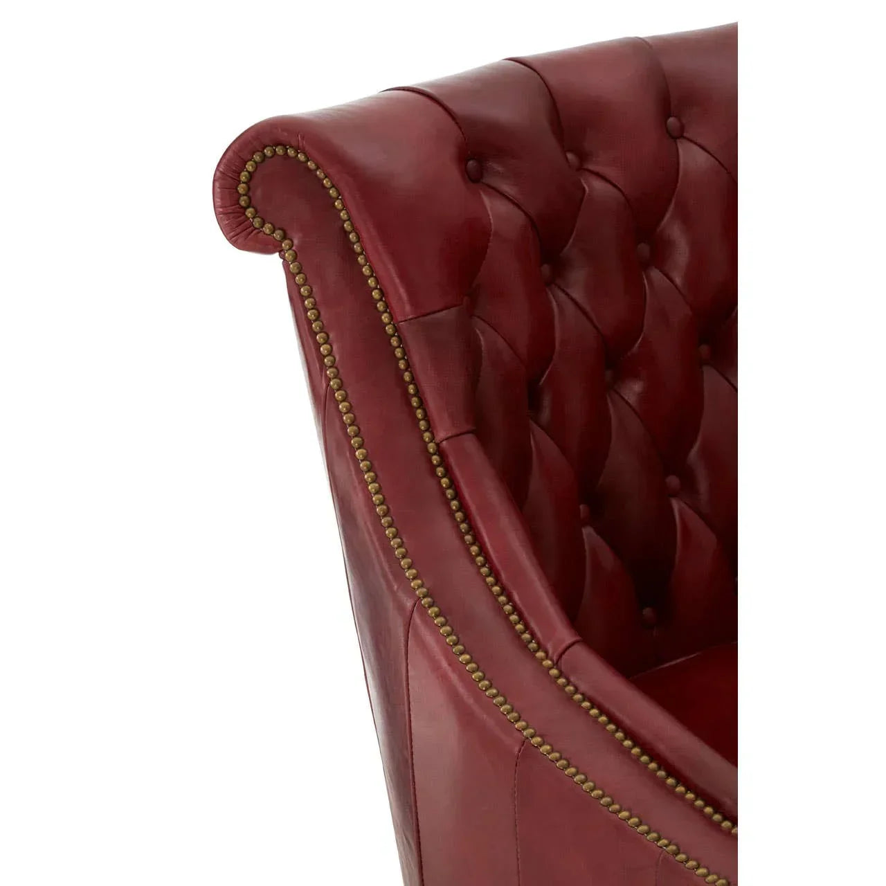 Red leather armchair with button tufting and brass stud detail on armrest