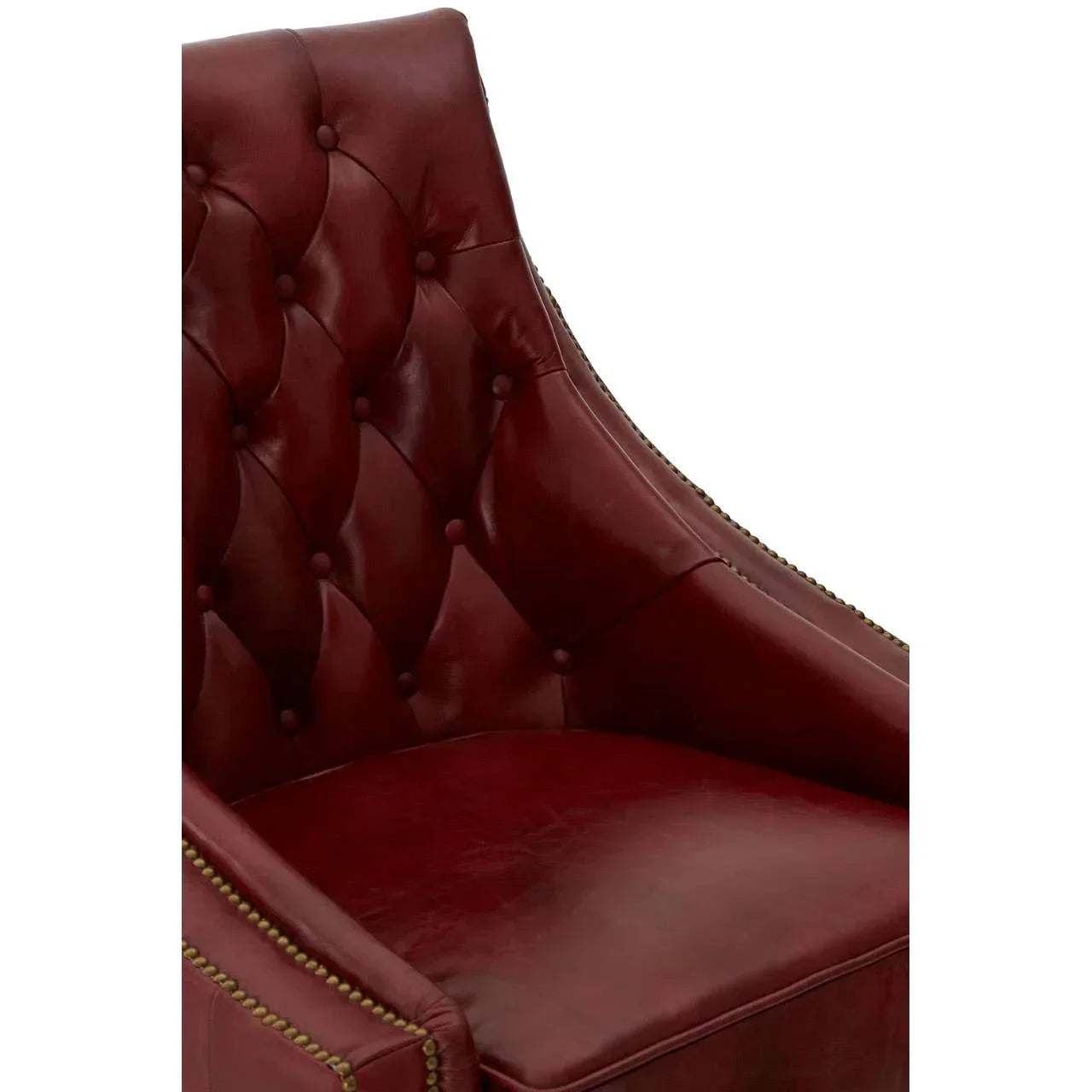Red leather armchair with button-tufted back and brass stud detailing, angled close-up