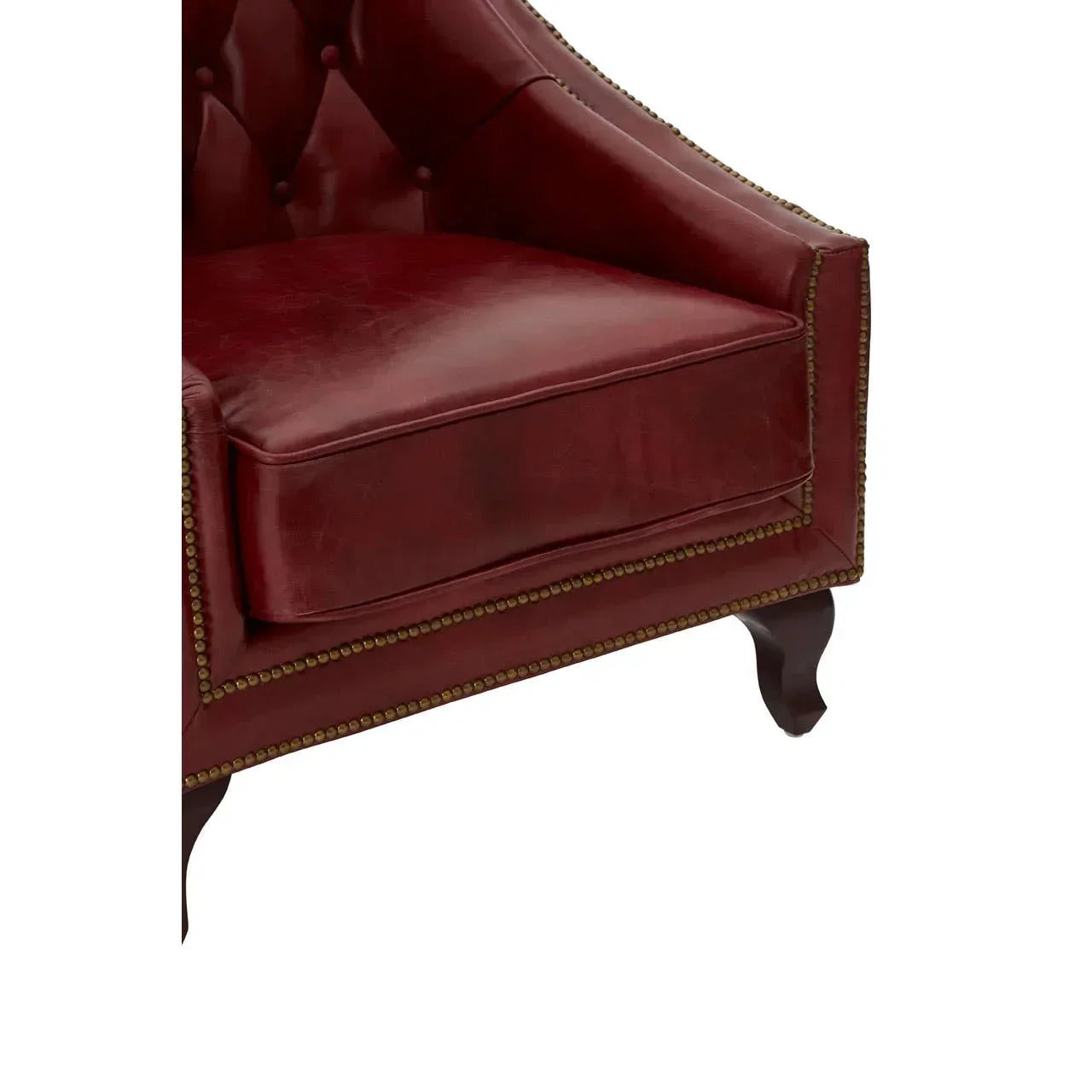 Burgundy leather armchair with studded trim and dark wooden legs, close-up view