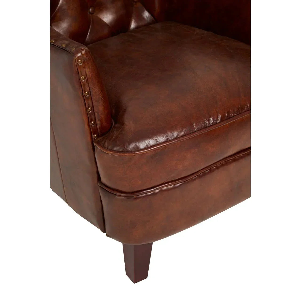 Brown leather armchair seat with button tufted back and studded armrest detail