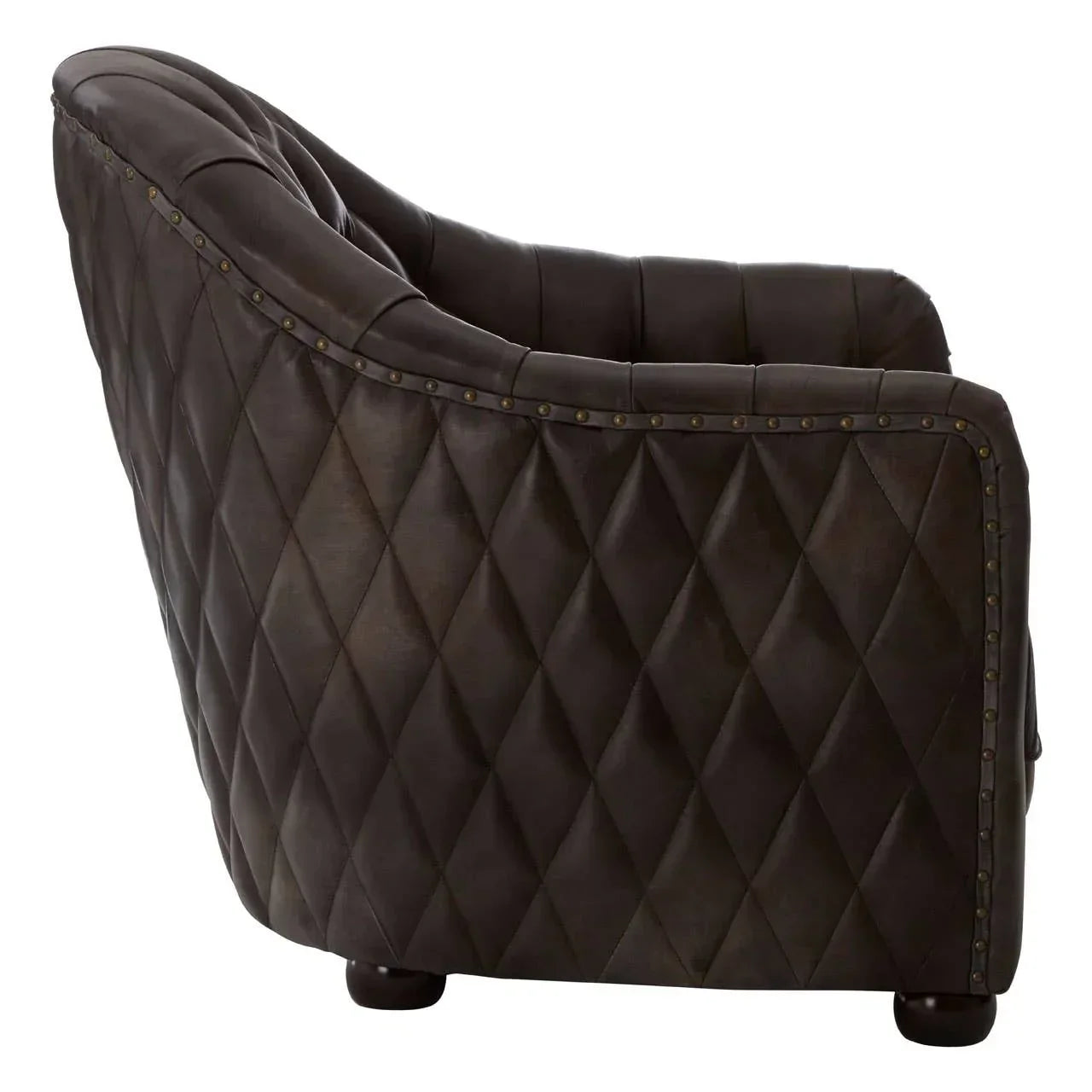Brown leather armchair with diamond quilted pattern and brass stud detail, side angle