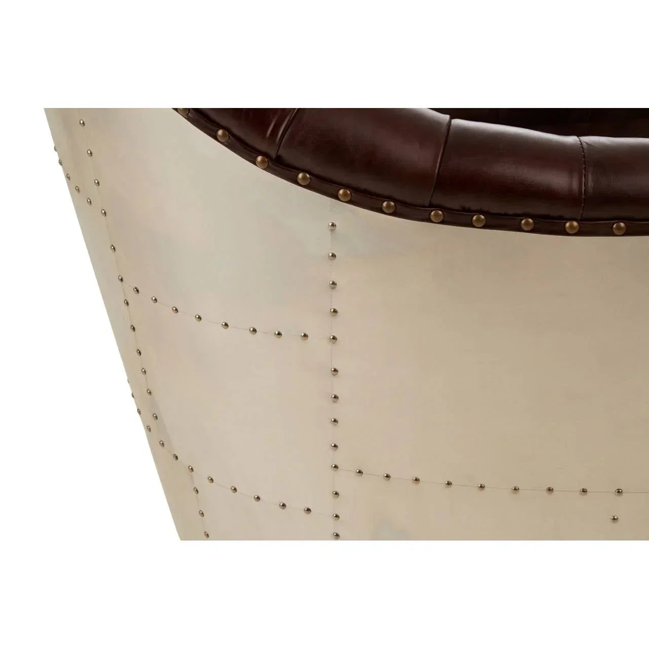 Close-up of brown leather armchair with metal panel and stud detail