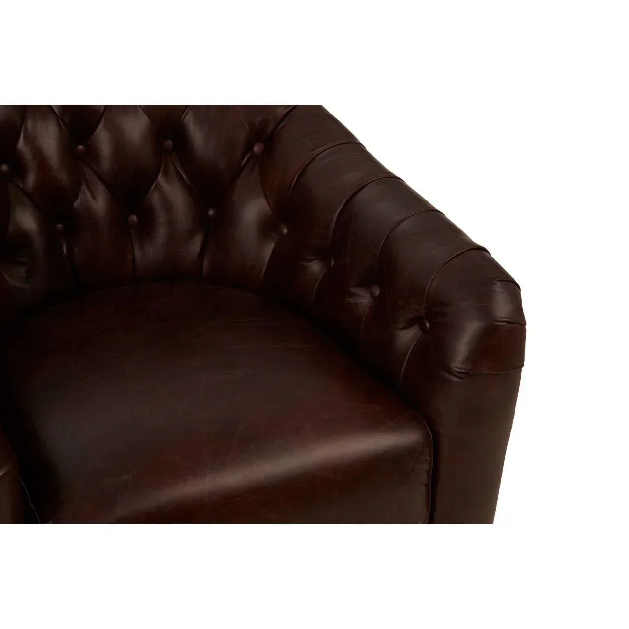 Closeup of dark brown leather sofa arm and seat with button-tufted upholstery