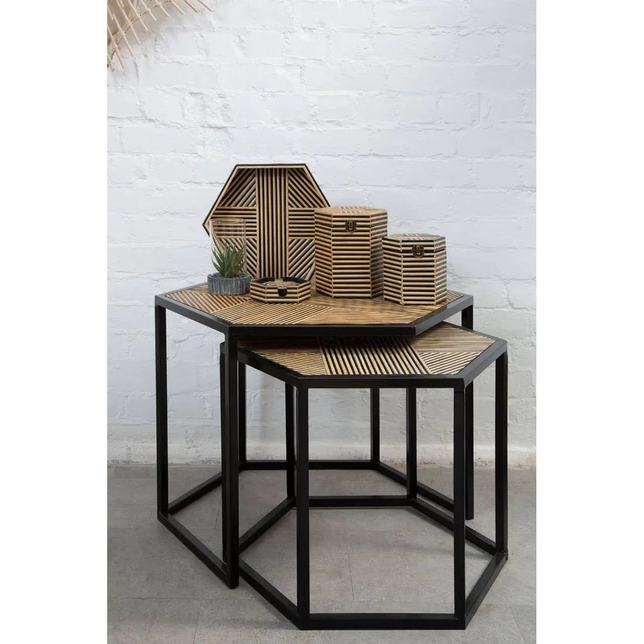 Set of two geometric nesting tables with black metal frames and wood patterned tops