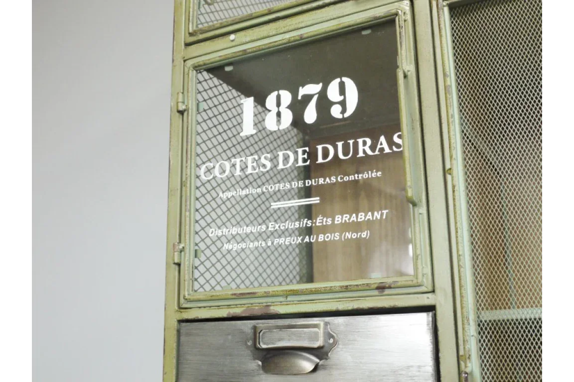 Industrial metal cabinet door with mesh panels and 1879 Cotes de Duras print on glass