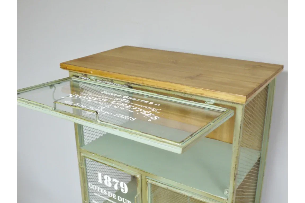 Green metal cabinet with wooden top and glass front panel, vintage style text detailing
