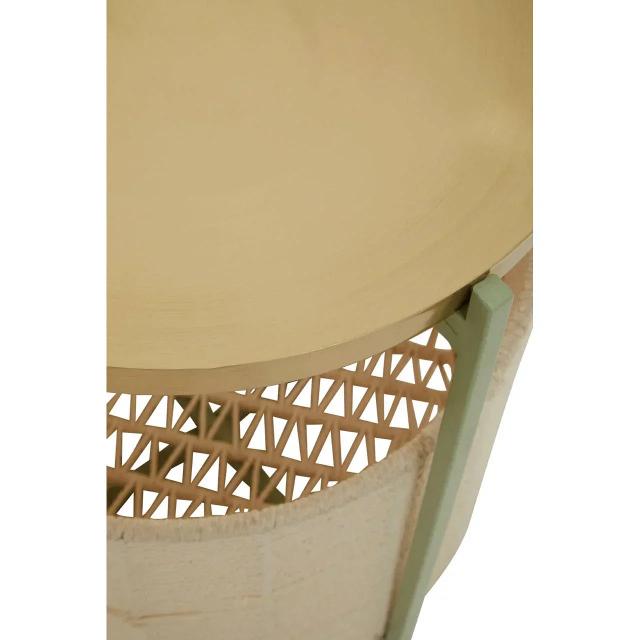 Close-up of round wooden side table with woven rattan panel and light green frame