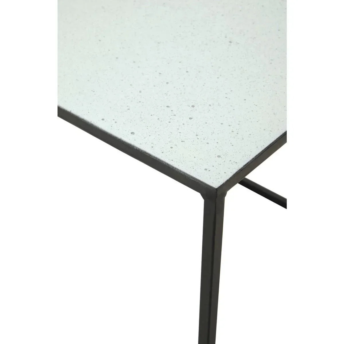 White speckled tabletop with black metal frame, close-up corner view