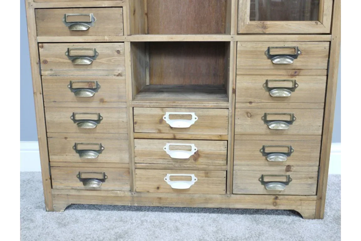 Rustic wooden storage drawers with brass and white handles on light carpet floor