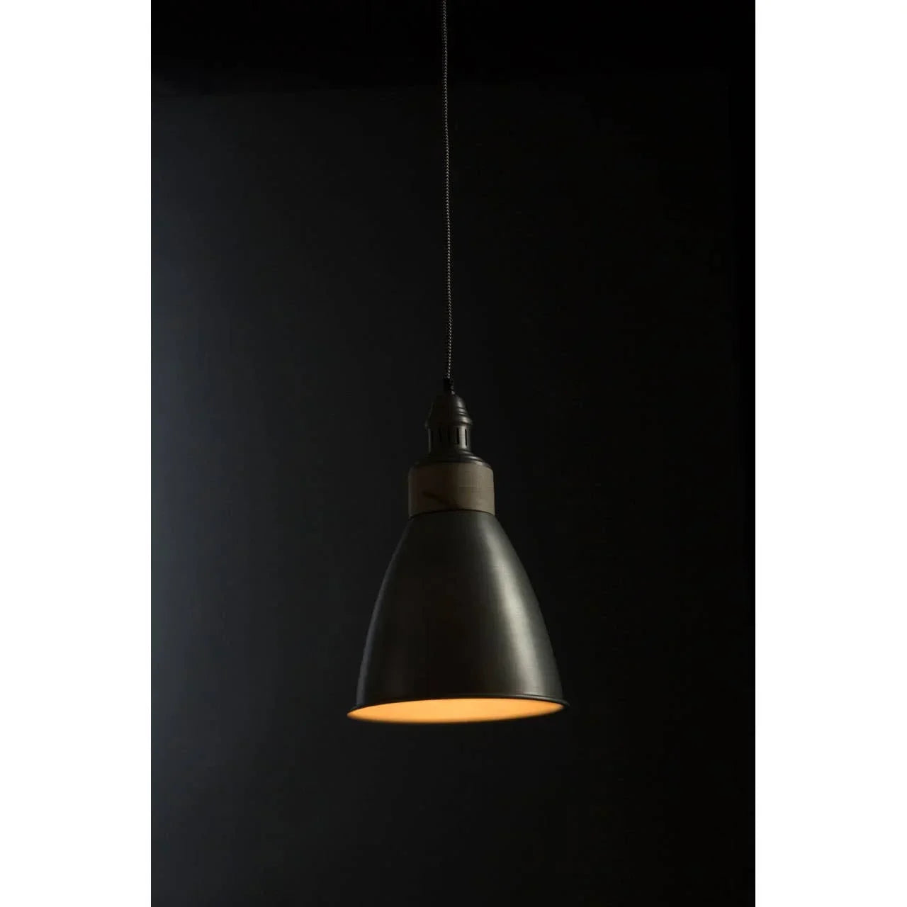 Black metal pendant ceiling light with cone shade against dark background