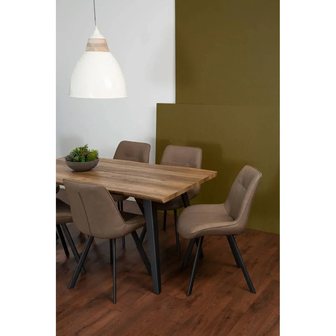 Rectangular wooden dining table with brown upholstered chairs on wood flooring