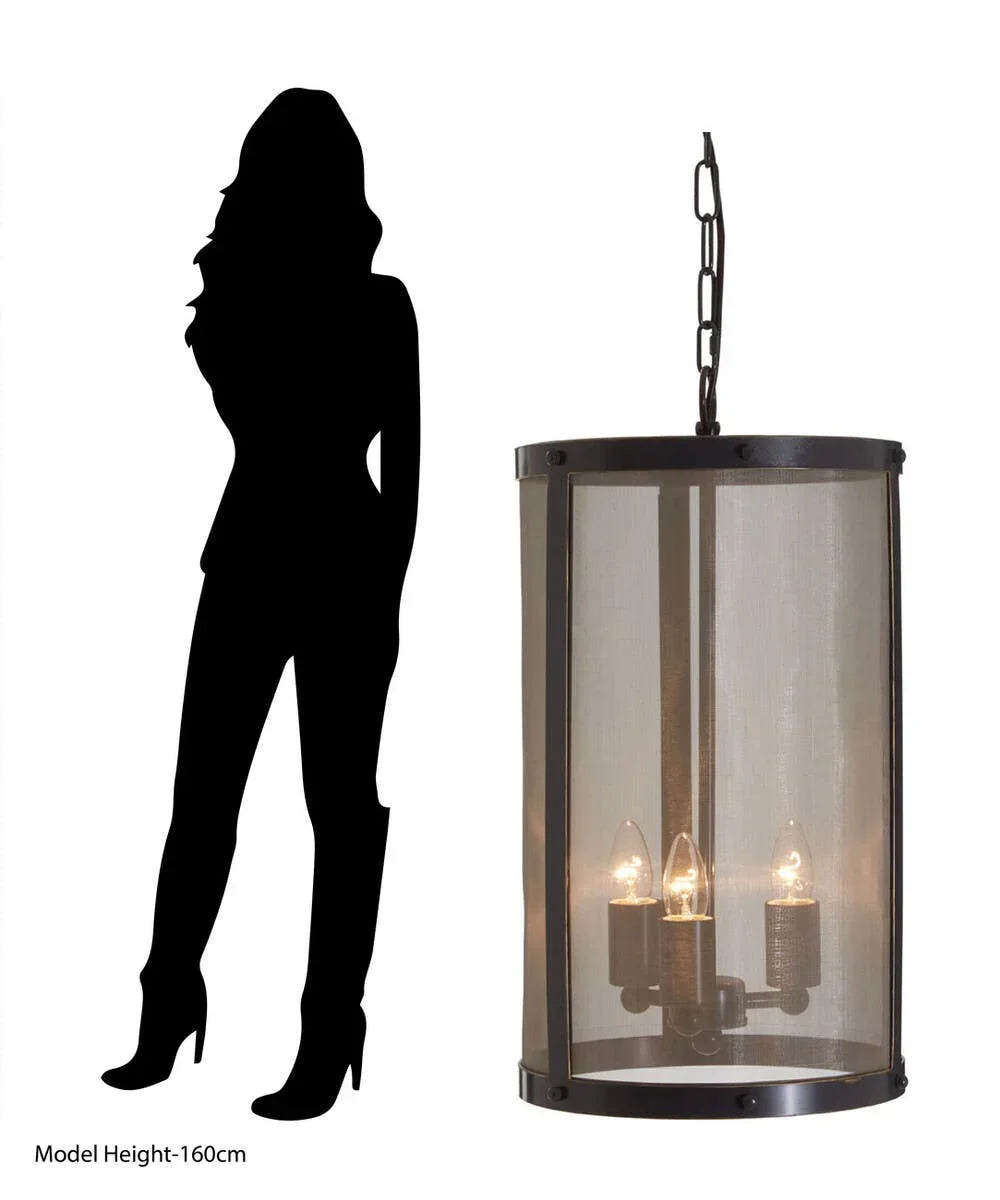 Large cylindrical pendant light with mesh shade and three bulbs, shown next to silhouette for scale