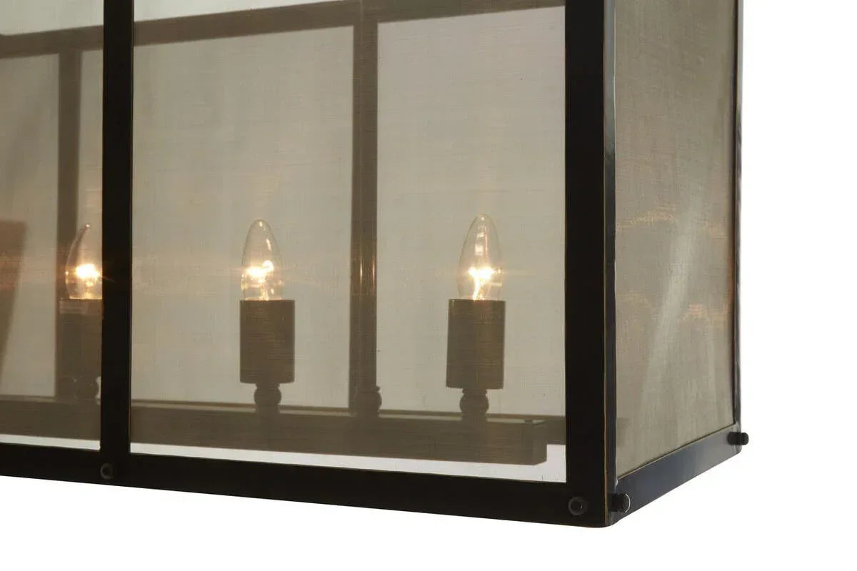 Closeup of rectangular metal frame pendant light with three exposed bulbs