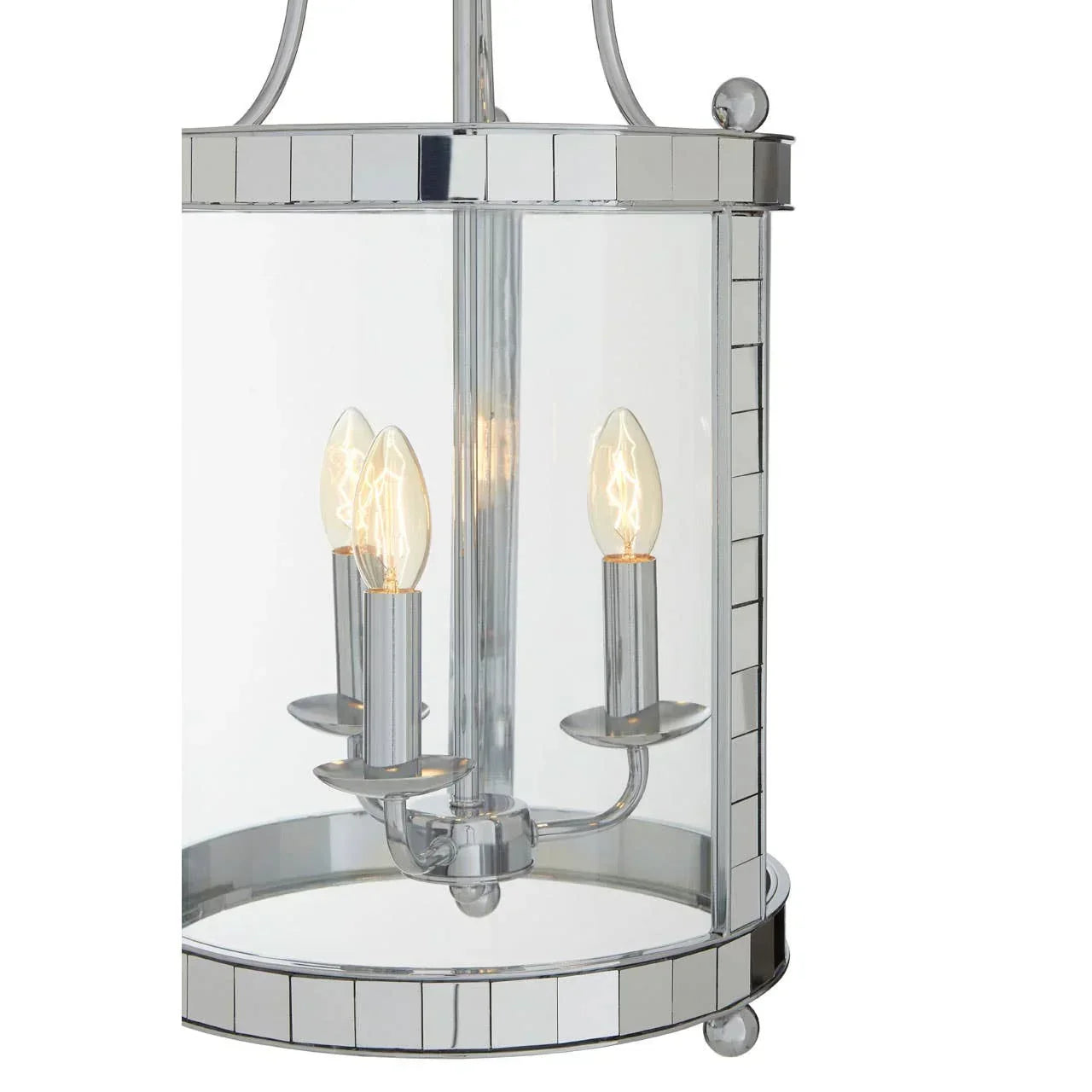 Chrome and glass pendant ceiling light with three candle-style bulbs lit inside