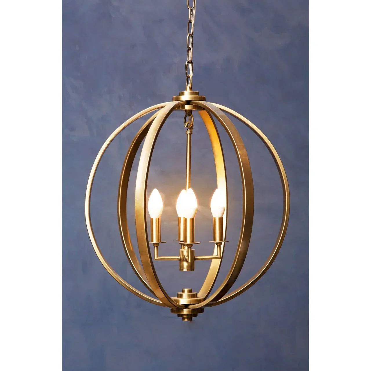 Gold metal pendant ceiling light with spherical frame and three candle bulbs