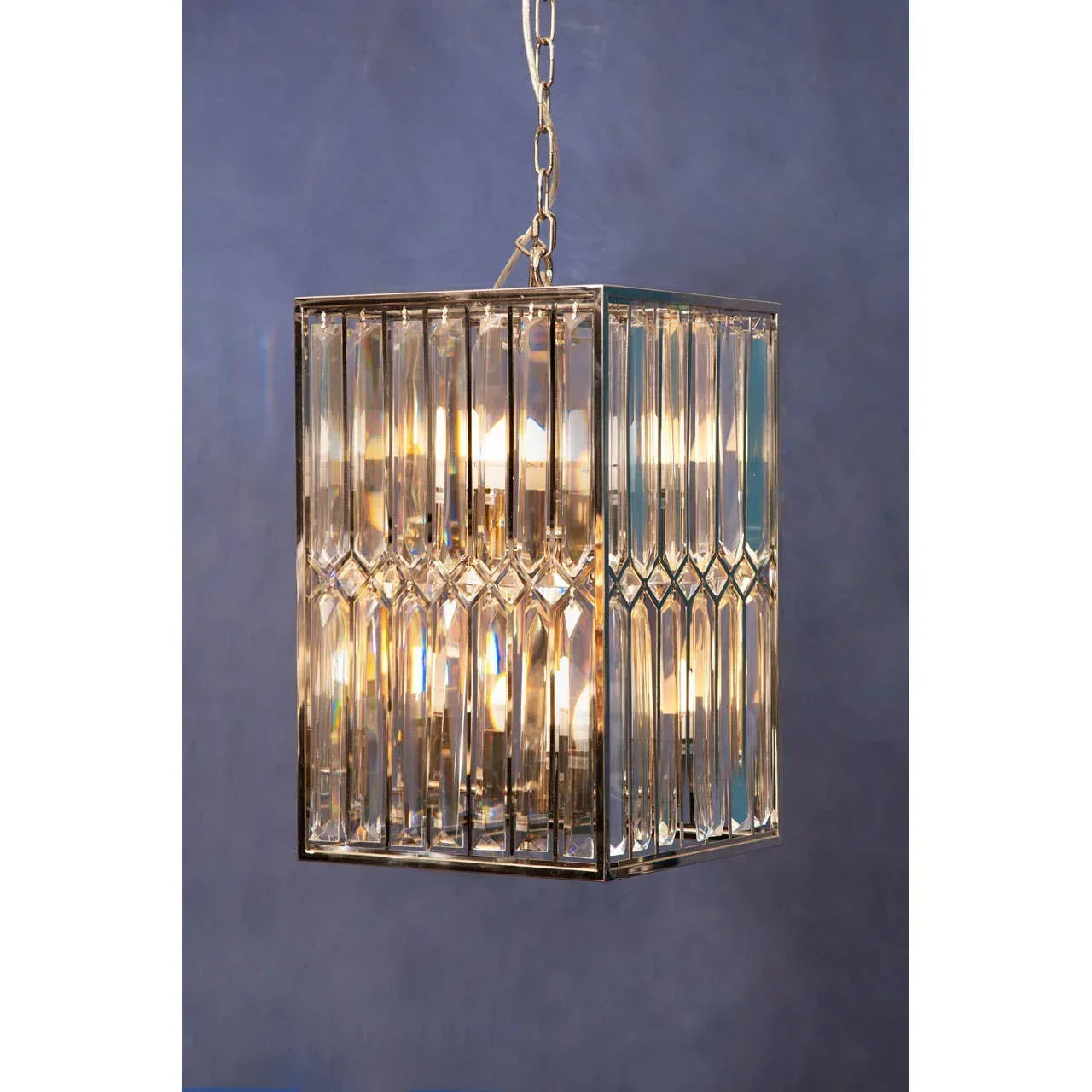 rectangular glass pendant light with chrome frame and chain against blue background