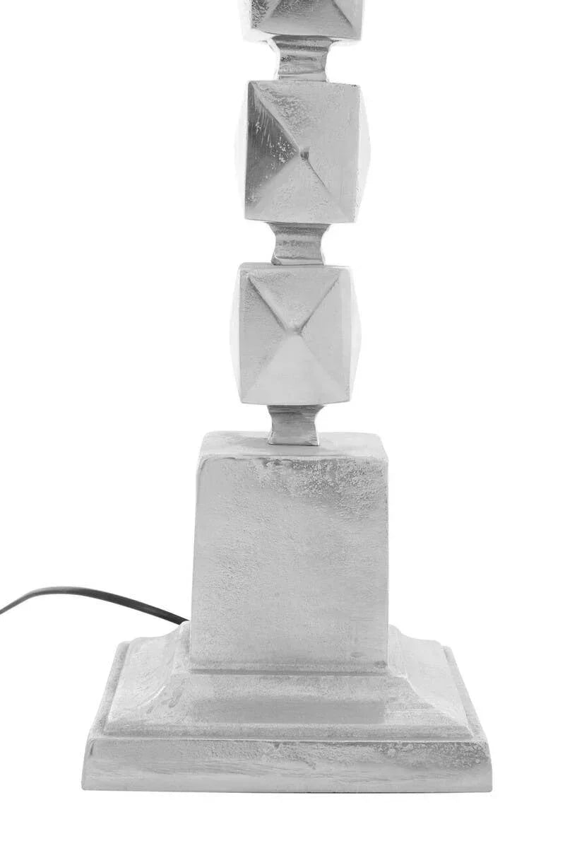 Silver table lamp base with geometric square pattern and visible black power cord