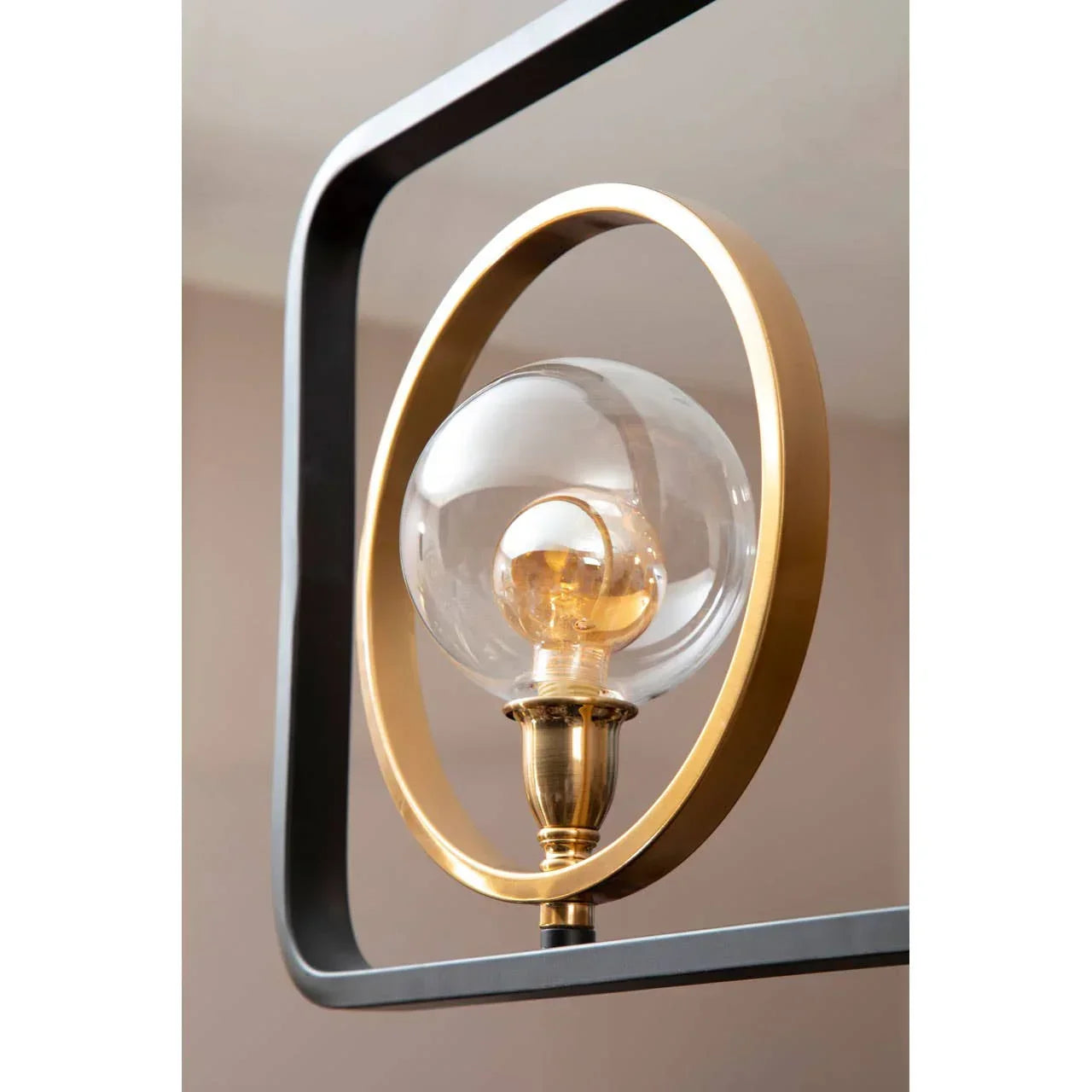 Modern pendant light with gold metal frame and clear glass globe shade