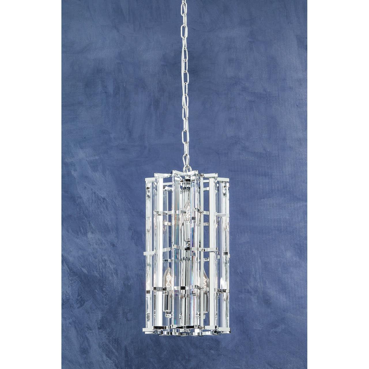 Chrome and crystal pendant light with cylinder design against blue wall