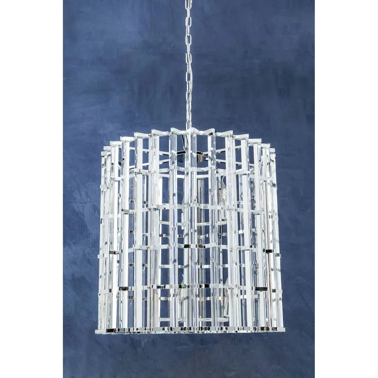Modern crystal chandelier with silver metal frame and geometric design, suspended by chain