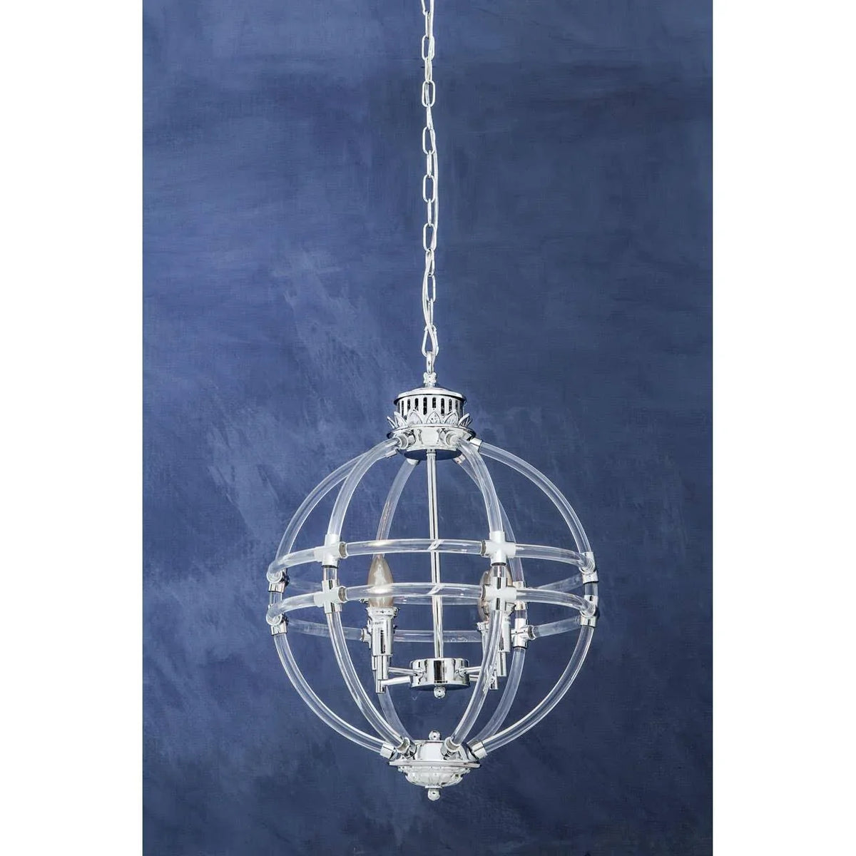 Chrome and glass modern chandelier light fixture with globe design against blue wall