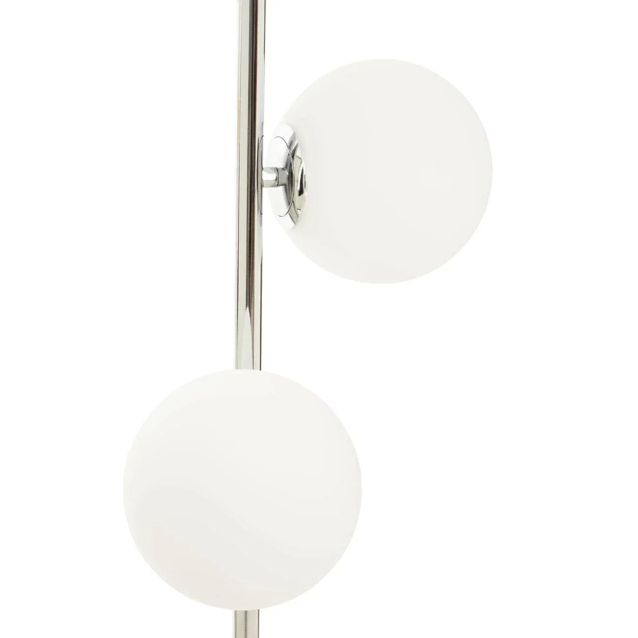 Chrome floor lamp with two white glass globe shades close-up