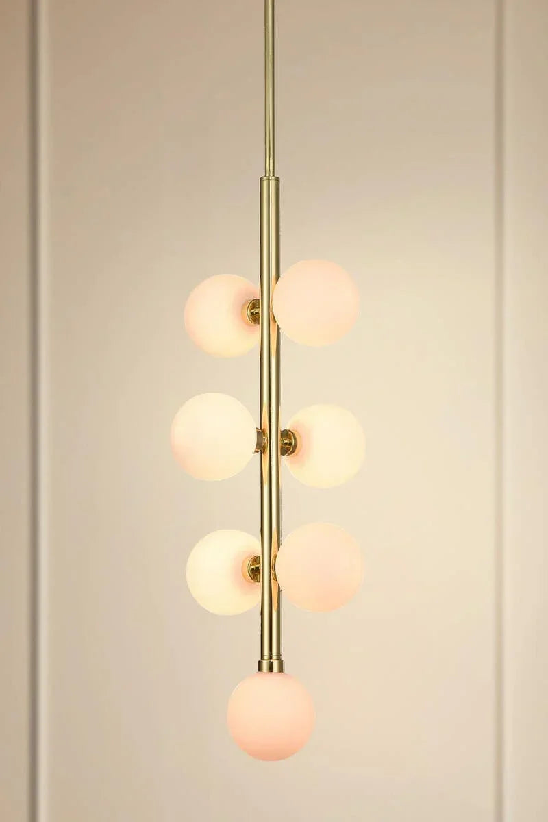 Modern pendant light with six frosted glass globe shades and gold finish, vertical view